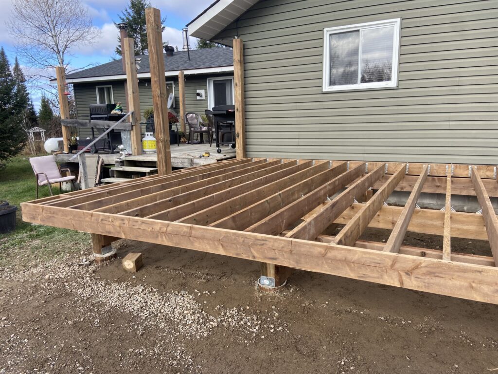 Decking boards being installed over a new deck frame.