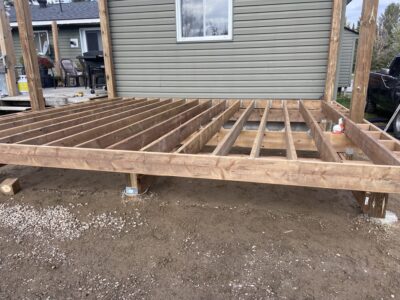Front elevation of the framed deck showing the beam, joists, and support posts