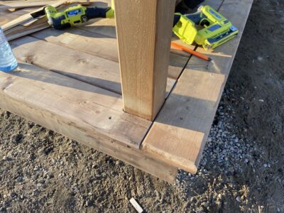 Close-up of deck boards neatly fitted around a post with a picture-frame border