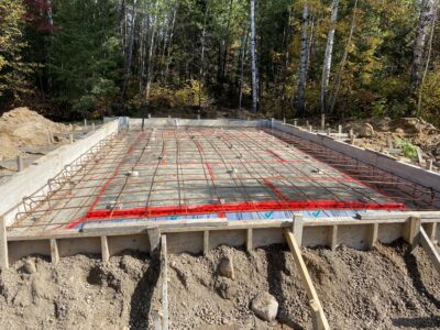 Garage slab formed with a steel rebar grid over rigid foam insulation