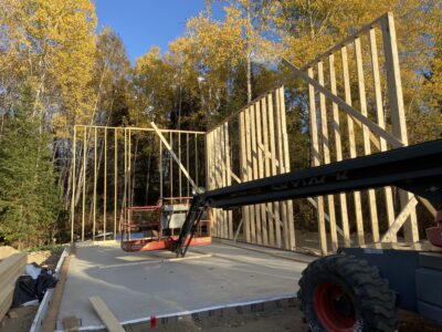First framed exterior wall raised and braced on the garage slab