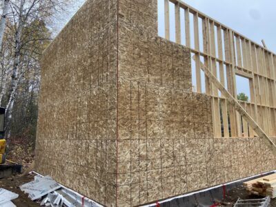 Garage corner fully sheathed in OSB with second-storey framing above