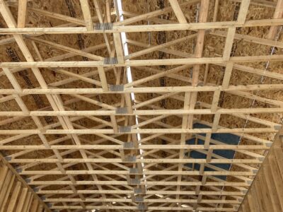 Interior view up at the garage roof trusses and OSB roof sheathing
