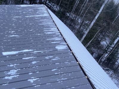 Finished metal garage roof dusted with the first snow of the season