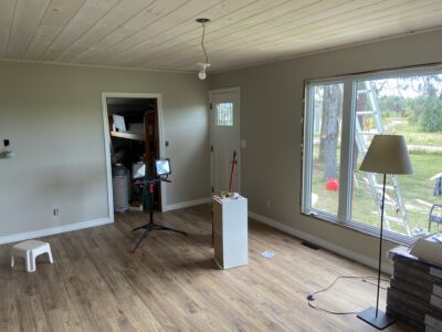 Finished open living space with a plank ceiling, new flooring, and a craftsman entry door